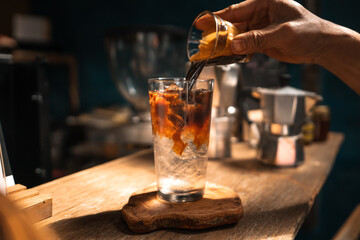 Wall Mural - Iced coffee in a cup,Pouring coffee into the cup