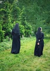 Two nuns are walking in the park