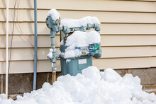 Natural Gas Meter Covered In Snow During Winter. Concept Of Energy Conservation, Residential Heating Costs And Natural Gas Production