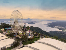 Aerial Of Sky Ranch Tagaytay, An Amusement Park With A Large Ferris Wheel And Other Rides, With Views Of Taal Volcano.