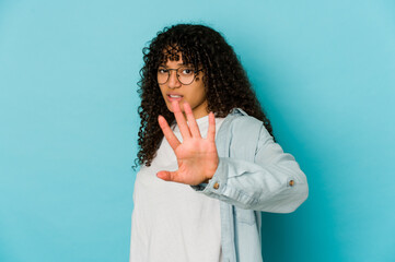 Young african american afro woman isolated rejecting someone showing a gesture of disgust.