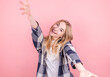 © Studio Nova - Happy cheerful young blonde woman rejoices at positive news or birthday present looking at the camera and holding out her hands to her with a joyful and charming smile