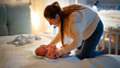 © Kyrylo Ryzhov - Young caring mother undressing her little baby and changing messy diapers at night before going to sleep. Concept of loving and caring parents, newborn babies and family happiness.