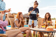 © Impact Photography - Friends having fun at an outdoor barbecue party