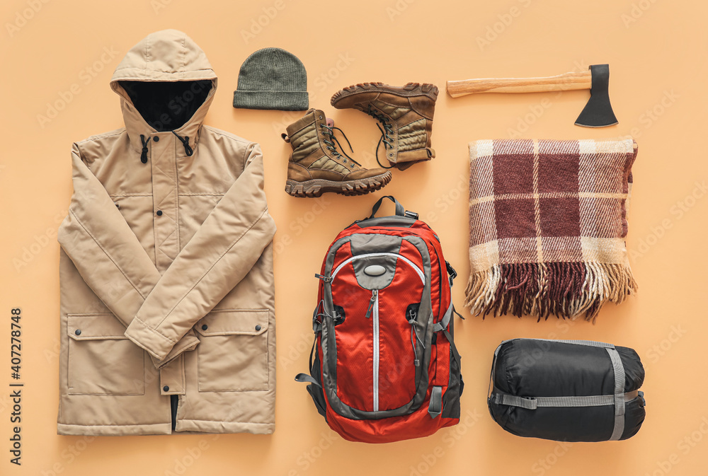 Equipment for hiking on color background