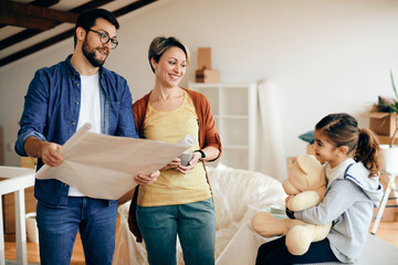 Wall Mural - Happy parents talking to their daughter while analyzing blueprints of their new home.