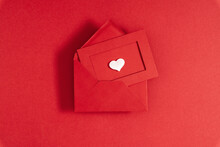 Creative Minimal Valentine's Day Concept. Envelope, Valentines, White  Hearts Confetti On Red Background. Flat Lay, Top View, Copy Space