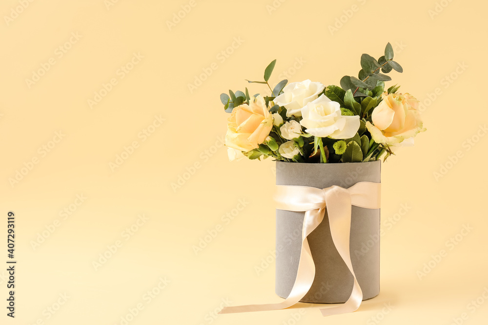 Gift box with beautiful flowers on color background