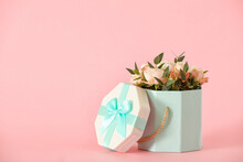 Gift Box With Beautiful Flowers On Color Background