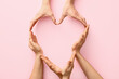 © Pixel-Shot - Hands making heart on color background