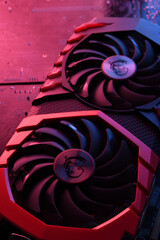 Poster - Computer game graphics card, videocard with two coolers on circuit board ,motherboard background. Close-up. With red-blue lighting