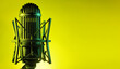 A Classic retro ribbon microphone in a vibrant yellow background with copy space for text