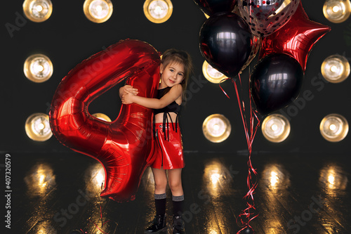 Girl dressed in rock style. Birthday baloons for party and celebrations. ballons abstract decoration. rock girl celebrating birthday.