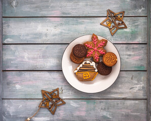 Multicolored gingerbread cookies with colorful glaze and decorative wooden stars