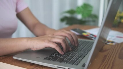 Close up professional office worker employee Working at home, Asian business woman typing on laptop computer sideview close up typing slow motion, successful business freelance business entrepreneur.