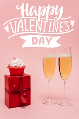 Wall Mural - champagne glasses near gift, cupcake and happy valentines day lettering on pink