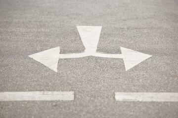 Selective focus of Crossroad arrow symbol  on the road