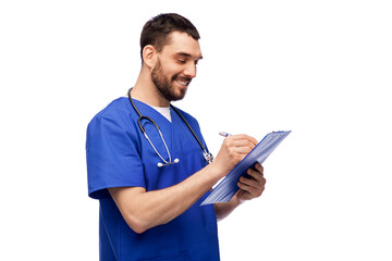 Poster - healthcare, profession and medicine concept - happy smiling doctor or male nurse in blue uniform writing medical report on clipboard over white background