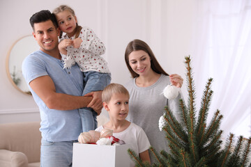 Sticker - Happy family with cute children decorating Christmas tree together at home