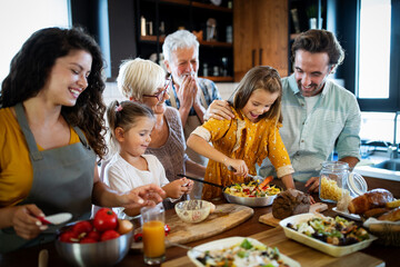 Wall Mural - cheerful family spending good time together while cooking in kitchen