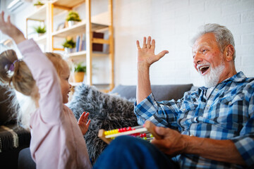 Wall Mural - Grandparent playing and having fun with their granddaughter