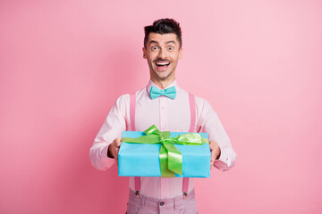 Sticker - Photo portrait of cheerful guy receiving present isolated on pastel pink colored background