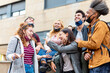 © MandriaPix - students of various nationalities joking with each other, resumption of normal social life with the protection of face masks, concept of optimism, positive view of the future