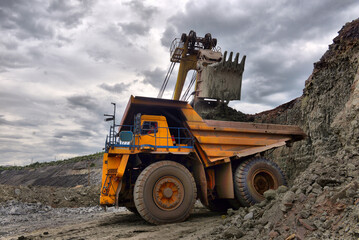Wall Mural - Large quarry dump truck. Loading the rock in the dumper. Loading coal into body work truck