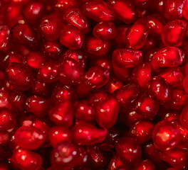 Wall Mural - Red pomegranate seeds on a white background. Close-up. Fruit, food. Photophone, wallpaper, texture, texture. Copy space.