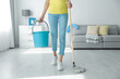 Woman with mop and bucket at home, closeup. Cleaning supplies