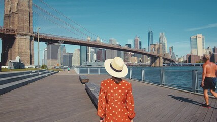 Wall Mural - Young woman walking by the Brooklyn Bridge, New York