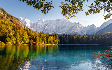 Impressively beautiful Fairy-tale mountain lake in Alps. Wonderful view of beautiful mountain landscape with calm lake Fusine.