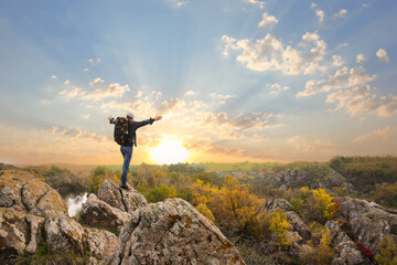 Wall Mural - Man with travel backpack enjoying beautiful nature on autumn day