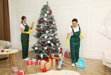 Canvas Print - Cleaning service team working in messy room after New Year party