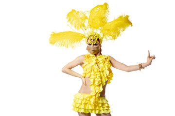 Wall Mural - Pointing. Beautiful young woman in carnival masquerade costume with feathers and golden face mask dancing on white background. Concept of holidays celebration, festive time, dance, party. Copyspace