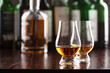 © Olga Miltsova - Bottle and glass of whisky spirit brandy on dark brown background