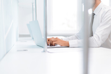 Wall Mural - background image of a business man working on an office laptop .