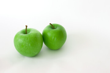 Fresh organic green apples isolated on white background. Healthy foods.