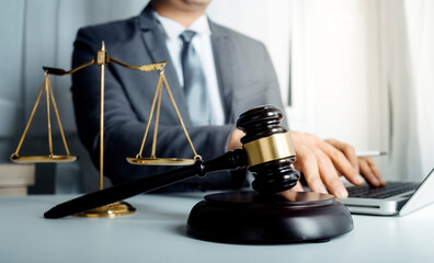 Business and lawyers discussing contract papers with brass scale on desk in office. Law, legal services, advice, justice and law concept picture with film grain effect	