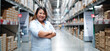 © NVB Stocker - Plus size female worker inspecting box of products while working in large warehouse. Banner panorama.