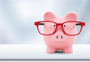  Cute piggy bank in glasses on the desk