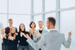 © yurolaitsalbert - rear view. business man standing in front of applauding business team