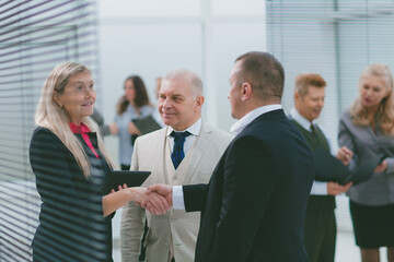 Poster - businesswoman and businessman shaking hands before the meeting