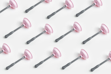 Pattern of grey pink toilet plunger on white background.