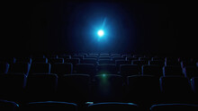 Interior Of Movie Theater With Empty Red Seats And Projector
