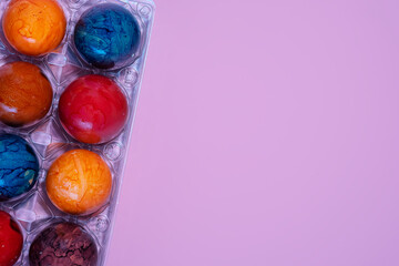 Boiled chicken painted eggs on a pink background.