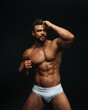 © Serge Lee - Fitness model in white underwear on black background