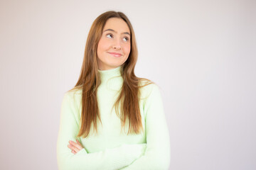 Attractive young girl wearing casual clothes standing isolated over white background, arms folded