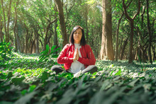 Healthy Lifestyle For Women Practicing Meditation And Yoga In The Forest. Young Woman Practicing Yoga Outdoors. Meditation Concept. Healthy Life Concept.