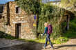 Pilgrim Girl Walking in Town of Triacastela Galicia Spain along the Way of St James Camino de Santiago Pilgrimage Trail